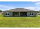 Spacious backyard featuring a covered patio, an outdoor tub, and a lush green lawn at 17887 Sw 72Nd Street Rd, Dunnellon, FL 34432