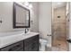 Modern bathroom showcasing a dark vanity with white countertop and tiled walk-in shower at 17887 Sw 72Nd Street Rd, Dunnellon, FL 34432