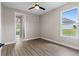 Bedroom with ceiling fan and wood-look floors, showcasing its simple elegance at 17887 Sw 72Nd Street Rd, Dunnellon, FL 34432