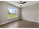 Bedroom with wood-look floors and window showing exterior view at 17887 Sw 72Nd Street Rd, Dunnellon, FL 34432