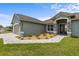 Charming exterior of a single-story home with stone accents and a paved walkway at 17887 Sw 72Nd Street Rd, Dunnellon, FL 34432