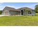 Well-maintained home featuring a lush lawn, a garage, and tasteful landscaping at 17887 Sw 72Nd Street Rd, Dunnellon, FL 34432