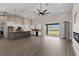 Open living space featuring a modern kitchen, sliding glass doors, and high ceilings at 17887 Sw 72Nd Street Rd, Dunnellon, FL 34432