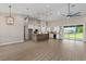 Spacious living room with high ceilings, modern lighting, and an open layout at 17887 Sw 72Nd Street Rd, Dunnellon, FL 34432