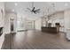 Open living area with modern kitchen, wood floors, and an adjacent bathroom at 17887 Sw 72Nd Street Rd, Dunnellon, FL 34432