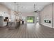 Bright, open-concept living space featuring a modern kitchen, wood floors, and fireplace at 17887 Sw 72Nd Street Rd, Dunnellon, FL 34432