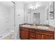 Bathroom with double sink vanity and shower-tub combo at 2297 Montbrook Pl, The Villages, FL 32162