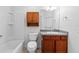 Bathroom featuring vanity, shower-tub combo, and wood cabinet storage at 2297 Montbrook Pl, The Villages, FL 32162