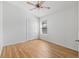 Bright bedroom with wood laminate flooring, ceiling fan, and large closet at 2297 Montbrook Pl, The Villages, FL 32162