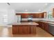 Bright kitchen featuring wooden cabinetry, stainless steel appliances, and a kitchen island at 2297 Montbrook Pl, The Villages, FL 32162