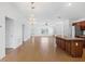 Spacious living room with wood flooring, chandelier and stainless steel appliances at 2297 Montbrook Pl, The Villages, FL 32162