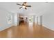 Open-concept living space featuring tile floors, a ceiling fan, and a view into the kitchen at 2297 Montbrook Pl, The Villages, FL 32162
