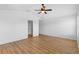 Bright main bedroom featuring wood flooring, closet, and ceiling fan at 2297 Montbrook Pl, The Villages, FL 32162