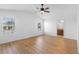 Bright main bedroom with ceiling fan, laminate floors, and ensuite bathroom at 2297 Montbrook Pl, The Villages, FL 32162