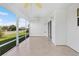 A wide view of a screened lanai, with white walls, tile floors and access to the outdoors at 2297 Montbrook Pl, The Villages, FL 32162