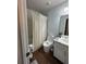 Cozy bathroom with wood-look floors, shower with curtain, toilet, and sink at 3875 Shaftbury Pl, Oviedo, FL 32765