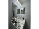 Bathroom vanity with modern fixtures, neutral wall color, and dual mirrors at 3875 Shaftbury Pl, Oviedo, FL 32765