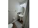 Modern half-bathroom features a pedestal sink, oval mirror, and sleek fixtures at 3875 Shaftbury Pl, Oviedo, FL 32765