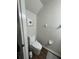 Compact half-bathroom with sleek, modern toilet and simple decor, features wood floors at 3875 Shaftbury Pl, Oviedo, FL 32765