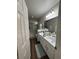 Bathroom with wood floors, double sinks, and a glass-enclosed shower at 3875 Shaftbury Pl, Oviedo, FL 32765