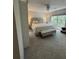 Bright bedroom featuring a king-size bed, ceiling fan, and large windows at 3875 Shaftbury Pl, Oviedo, FL 32765