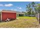 Spacious backyard featuring a shed, grassy lawn, and a view of the home's exterior at 3968 Sw 131St Place Rd, Ocala, FL 34473