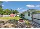 Large backyard with a fire pit, shed, and green house exterior at 3968 Sw 131St Place Rd, Ocala, FL 34473