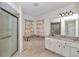 This spacious bathroom features a soaking tub, walk-in shower, double vanity, and wood-look tile floors at 3968 Sw 131St Place Rd, Ocala, FL 34473