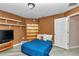 Cozy bedroom features a blue bed, built-in bookcase, and shelves at 3968 Sw 131St Place Rd, Ocala, FL 34473