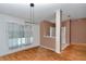 Bright dining area with wood floors, modern lighting, and a view into the living space at 3968 Sw 131St Place Rd, Ocala, FL 34473