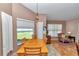 Inviting dining area with a wooden table, chairs, and view to the living area at 3968 Sw 131St Place Rd, Ocala, FL 34473