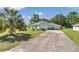 The home features a long driveway and an attached garage, enhancing its curb appeal at 3968 Sw 131St Place Rd, Ocala, FL 34473