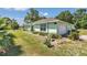 Well-maintained exterior of the home featuring a lush lawn, landscape and an attached two-car garage at 3968 Sw 131St Place Rd, Ocala, FL 34473