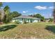 Inviting one-story home featuring a lush green lawn and mature trees at 3968 Sw 131St Place Rd, Ocala, FL 34473