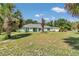 Well-kept one-story home with mature landscaping, featuring a green exterior and ample yard space at 3968 Sw 131St Place Rd, Ocala, FL 34473