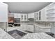 Kitchen featuring white cabinets and granite countertops at 3968 Sw 131St Place Rd, Ocala, FL 34473