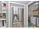 Stainless steel refrigerator in the kitchen next to the laundry area at 3968 Sw 131St Place Rd, Ocala, FL 34473