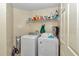 Laundry room with a washer, dryer, and storage shelf at 3968 Sw 131St Place Rd, Ocala, FL 34473