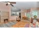 Open-concept living room with wood floors connecting the kitchen and dining area at 3968 Sw 131St Place Rd, Ocala, FL 34473