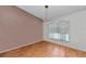 Cozy living room featuring wood flooring, a stylish light fixture, and bright natural light at 3968 Sw 131St Place Rd, Ocala, FL 34473