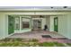 Large covered back patio features dual doors and a ceiling fan at 3968 Sw 131St Place Rd, Ocala, FL 34473