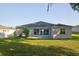 The backyard features a well-manicured lawn, patio, and view of the house at 4261 Sw 62Nd Loop, Ocala, FL 34474