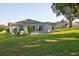 The backyard features a well-manicured lawn and back exterior of the house at 4261 Sw 62Nd Loop, Ocala, FL 34474