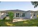 The backyard features a well-manicured lawn, patio, and back exterior of the house at 4261 Sw 62Nd Loop, Ocala, FL 34474