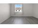 A simple bedroom with hard surface floors and a view from the bright window at 4261 Sw 62Nd Loop, Ocala, FL 34474