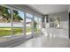 Sunroom dining area features multiple windows with backyard view and kitchen with sink at 4261 Sw 62Nd Loop, Ocala, FL 34474