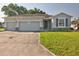 Charming single-story home featuring a three-car garage and well-maintained lawn at 4261 Sw 62Nd Loop, Ocala, FL 34474
