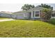 The front exterior features a large driveway, attached garage, and well-maintained lawn at 4261 Sw 62Nd Loop, Ocala, FL 34474