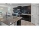 This kitchen boasts dark cabinetry, granite countertops, tile backsplash, and stainless steel appliances at 4261 Sw 62Nd Loop, Ocala, FL 34474