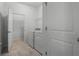 Spacious laundry room with washer and dryer hookups, wire shelving and tile floors at 4261 Sw 62Nd Loop, Ocala, FL 34474